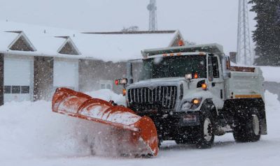 snow plow working to clear Preston's roads